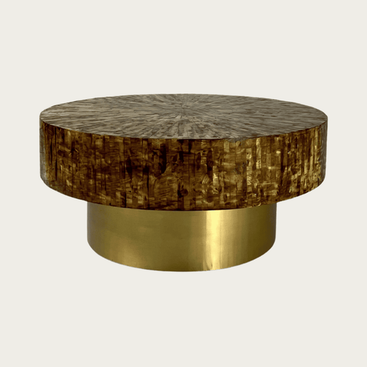 Round brown mother of pearl inlay coffee table with a rich textured surface and bold gold base. A luxurious centerpiece for living spaces.