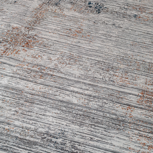 Core Cotton rug in 400x300 cm featuring muted tones of grey, ivory, blue, and burnt orange in a softly distressed modern texture.