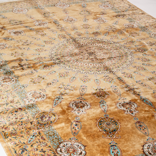 Golden silk rug featuring a central medallion, floral border, and teal highlights, shown in detailed close-ups and full view.