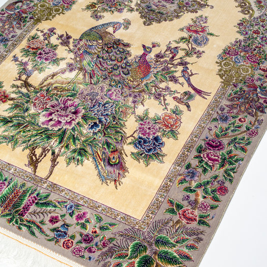 Luxurious ivory silk rug featuring peacocks, floral motifs, and intricate detailing, handcrafted with multicolored threads.