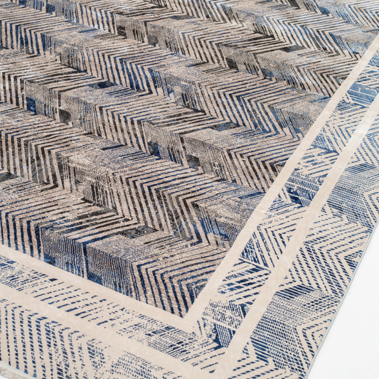 Eclipse cotton rug featuring a bold chevron pattern in grey, blue, and ivory with a distressed texture, perfect for contemporary interiors.