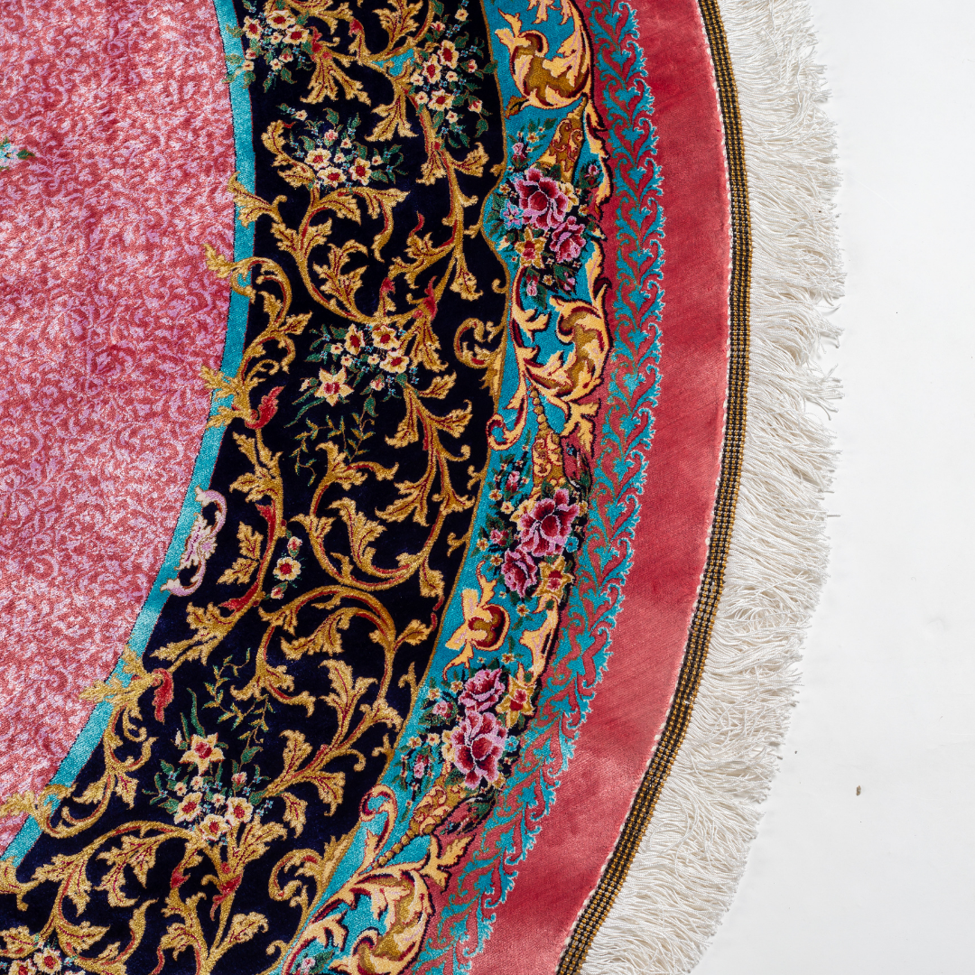 Round silk rug with a vibrant pink base, intricate navy floral borders, and detailed medallion center, 200x200 cm.