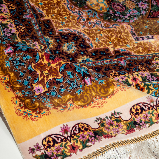 Luxurious silk rug featuring floral medallion pattern in gold, ivory, rose, and turquoise tones with intricate craftsmanship.