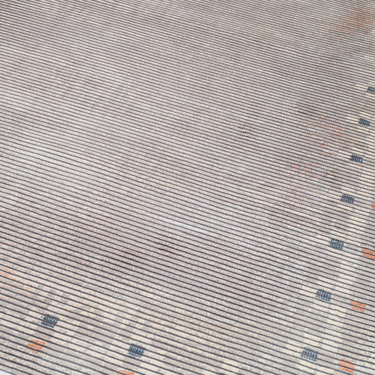 Grey striped Cotton rug with fine orange and blue motif border, in 400x300 cms size, perfect for modern interiors.