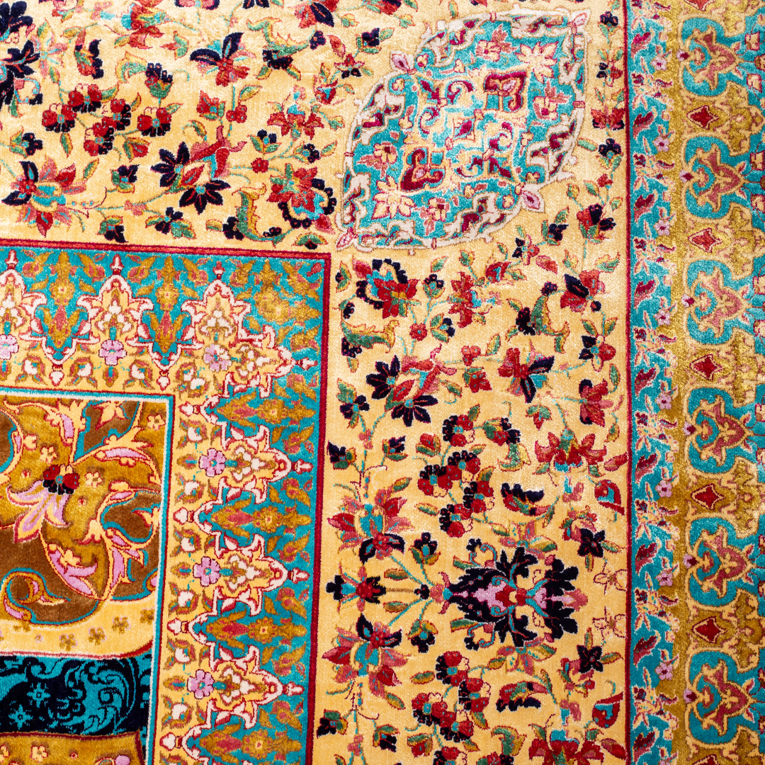 Spot silk rug in 350x250 cms featuring turquoise and mustard floral designs with a detailed medallion and golden border work.