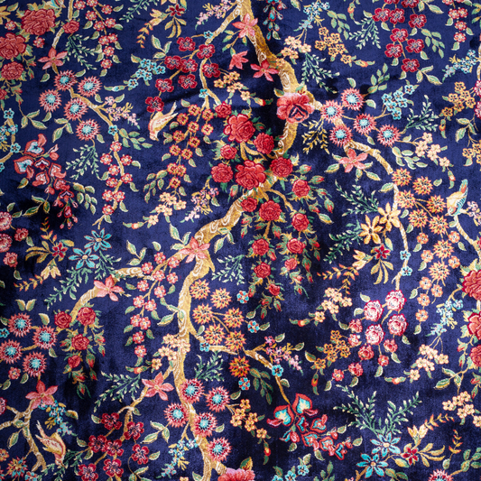 Silk rug in navy with crimson, pink, jade, and gold floral design. Tree-of-life motif. Size: 225x150 cm. Ships worldwide.