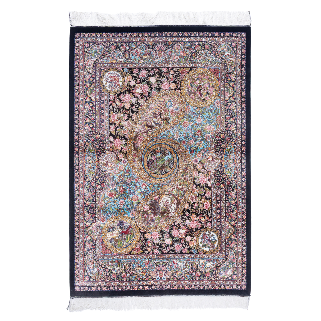 Close-up of the Veo Persian silk rug featuring a floral and bird pattern in navy, turquoise, and gold tones. 150x100 cm size.
