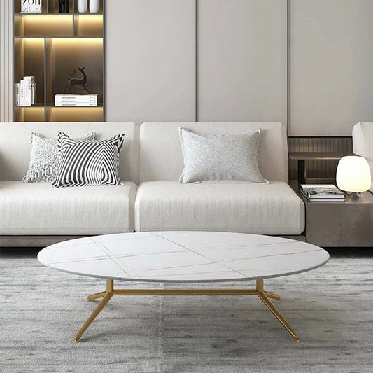 Oval white marble coffee table with subtle gold vein detailing and sleek gold legs
