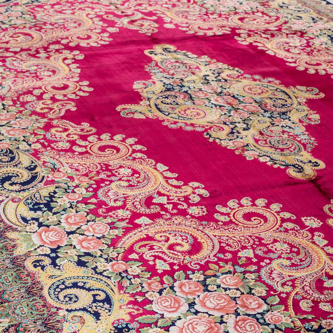 Zane Silk Rug with crimson red base, floral medallion pattern, intricate gold scrolls, and a navy border, crafted in fine silk with detailed motifs.