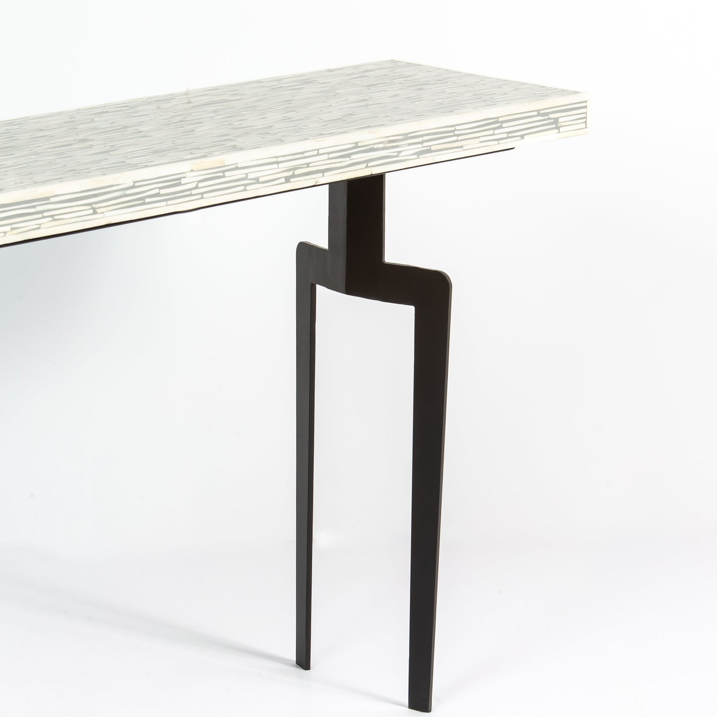 Table with a bone inlay top and black legs