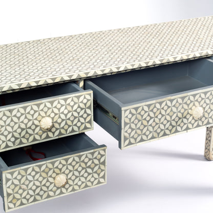 Grey bone inlay console desk with five drawers and geometric design, handcrafted with detailed knobs and artisan craftsmanship.