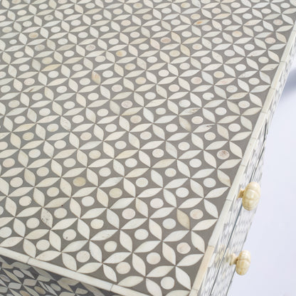 Grey bone inlay console desk with five drawers and geometric design, handcrafted with detailed knobs and artisan craftsmanship.