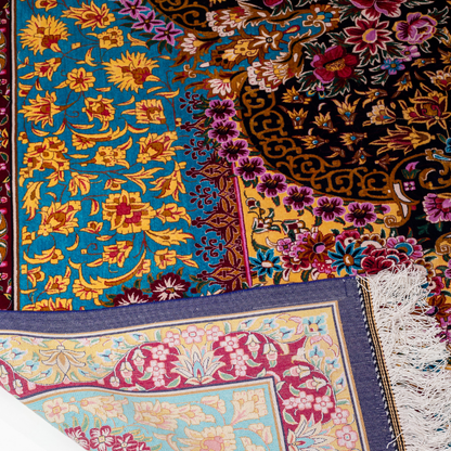 The Amore silk rug features an ornate floral medallion over a navy base, with vivid accents of turquoise, gold, and crimson in 350x250 cm.