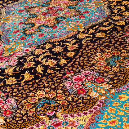 The Amore silk rug features an ornate floral medallion over a navy base, with vivid accents of turquoise, gold, and crimson in 350x250 cm.