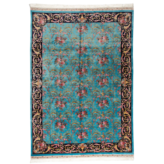 The Archie silk rug in turquoise with red floral motifs and golden scrolls, featuring a black ornamental border and exquisite handwoven detailing.