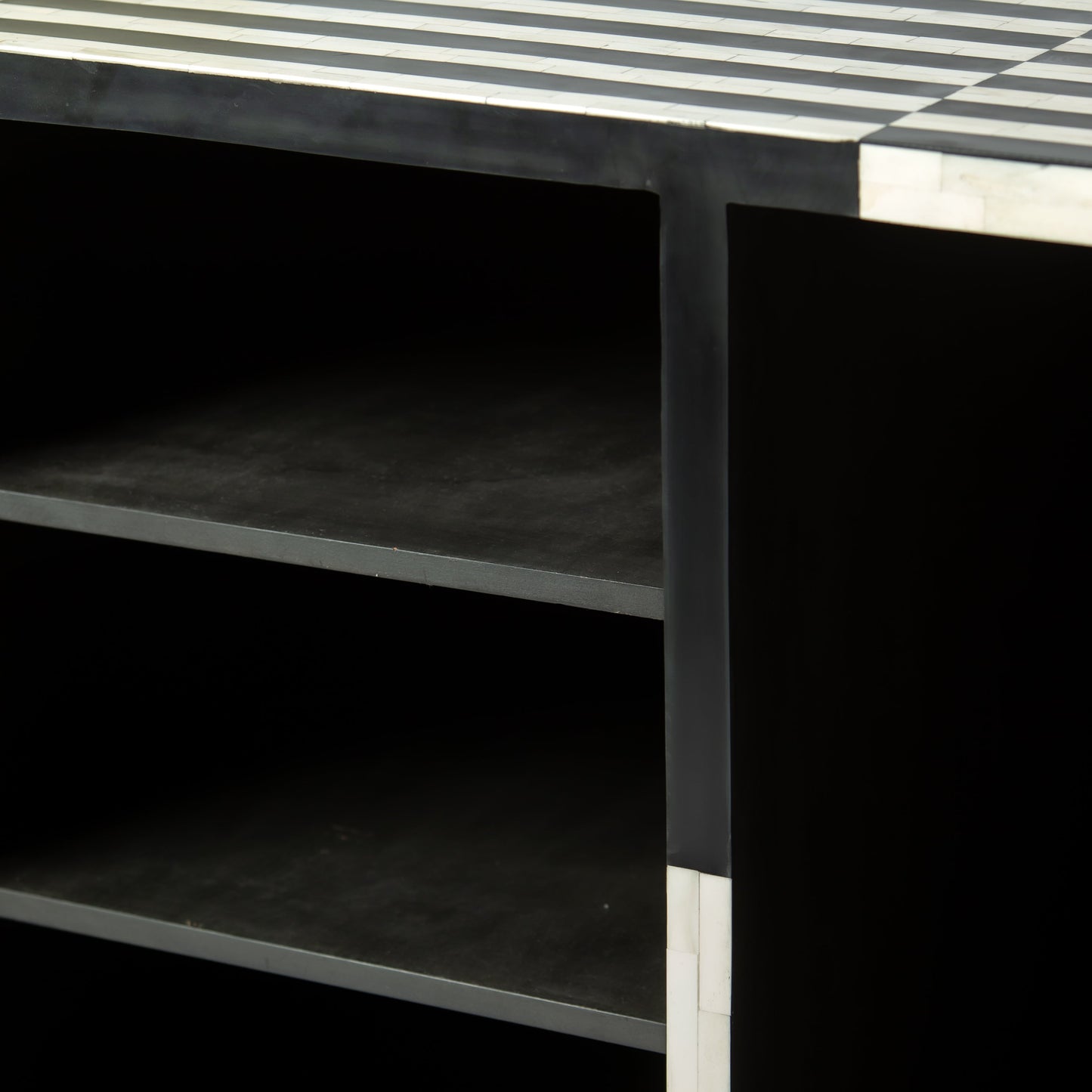 Black bone inlay bar cabinet with bold geometric front and open back storage, handmade with brass base and striking design.
