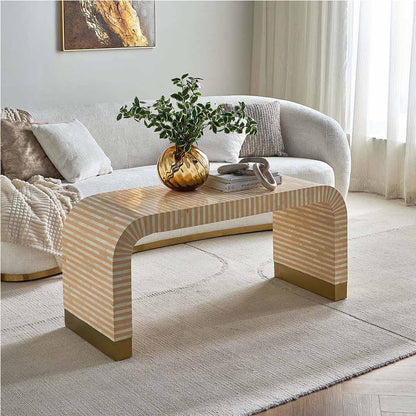 Modern beige bone inlay coffee table with curved edges and gold base.