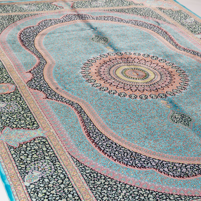 Luxurious silk rug in turquoise with intricate medallion and floral patterns, perfect for refined interiors.