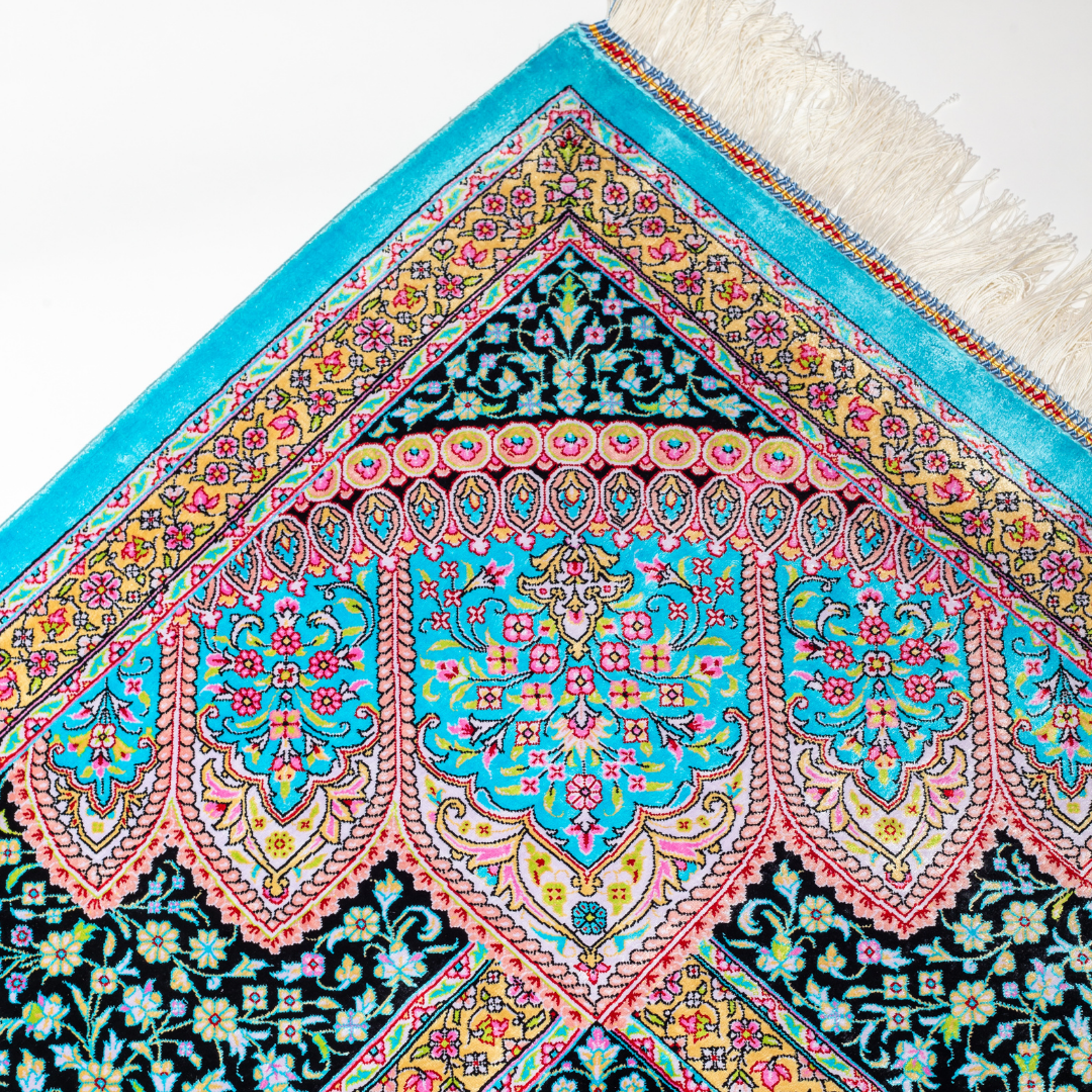 Luxurious silk rug in turquoise with intricate medallion and floral patterns, perfect for refined interiors.