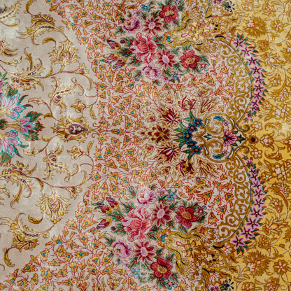 Handwoven silk rug in cream, gold, and blush tones featuring floral medallion, delicate vines, and ornate pastel detailing throughout.

