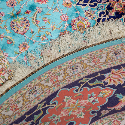 Cello Silk Rug with a turquoise base, intricate central floral medallion, and ornate navy border with Persian floral motifs and fine silk texture.