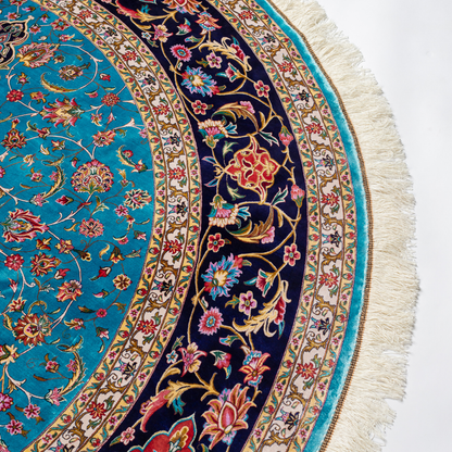 Cello Silk Rug with a turquoise base, intricate central floral medallion, and ornate navy border with Persian floral motifs and fine silk texture.