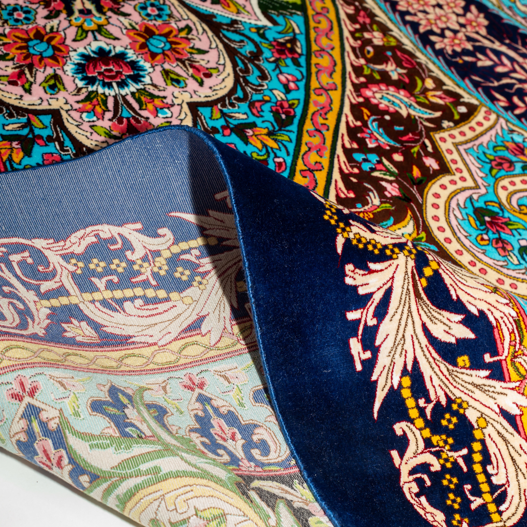 High-detail silk rug featuring a central medallion, ornate paisleys, and floral motifs in jewel tones. Perfect for elegant interiors.