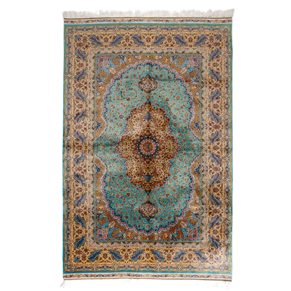 Intricately handwoven silk rug with medallion design, turquoise base, and ornate gold-maroon border for elegant interior styling.

