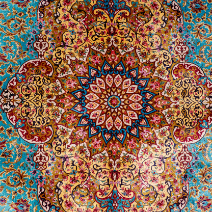 Intricately handwoven silk rug with medallion design, turquoise base, and ornate gold-maroon border for elegant interior styling.

