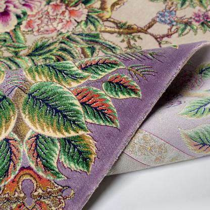 Elegant silk rug with peacock and floral design in soft pastels. Framed by intricate vine borders. A handwoven masterpiece of grace.

