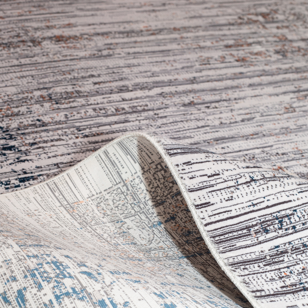 Core Cotton rug in 400x300 cm featuring muted tones of grey, ivory, blue, and burnt orange in a softly distressed modern texture.