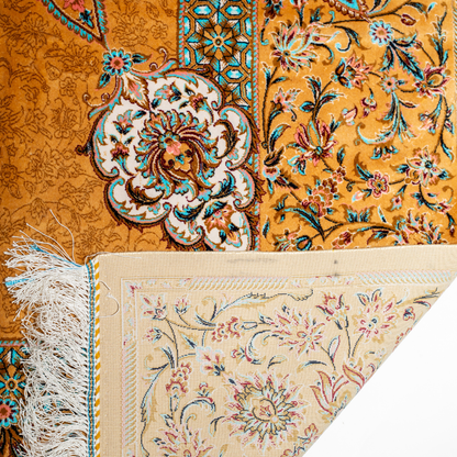 Golden silk rug featuring a central medallion, floral border, and teal highlights, shown in detailed close-ups and full view.