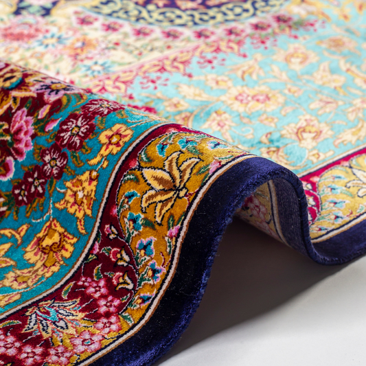 Luxurious silk rug with intricate medallion and floral design in jewel tones. Elegant handwoven detailing for sophisticated interiors.

