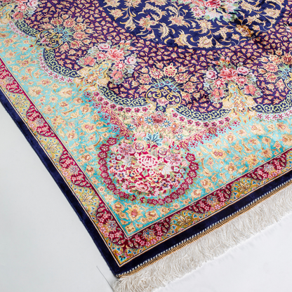 Luxurious silk rug with intricate medallion and floral design in jewel tones. Elegant handwoven detailing for sophisticated interiors.

