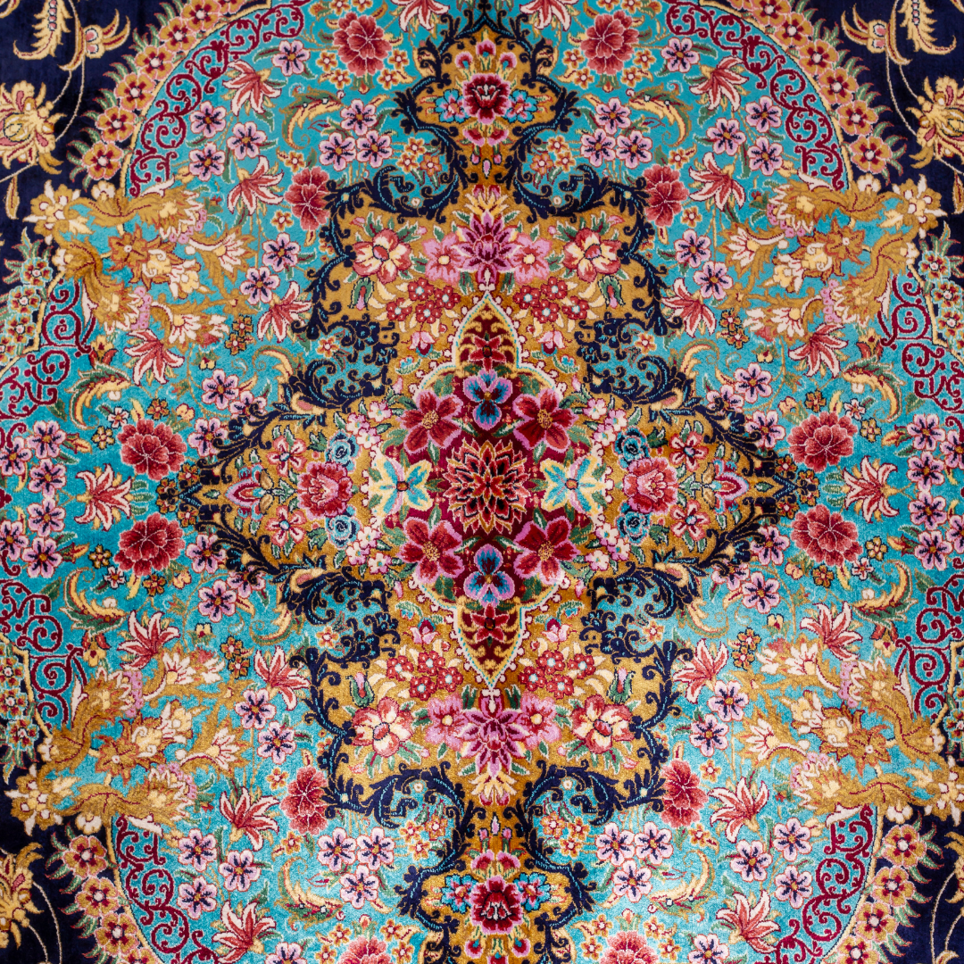 Luxurious silk rug with intricate medallion and floral design in jewel tones. Elegant handwoven detailing for sophisticated interiors.

