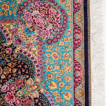 Luxurious silk rug with intricate medallion and floral design in jewel tones. Elegant handwoven detailing for sophisticated interiors.

