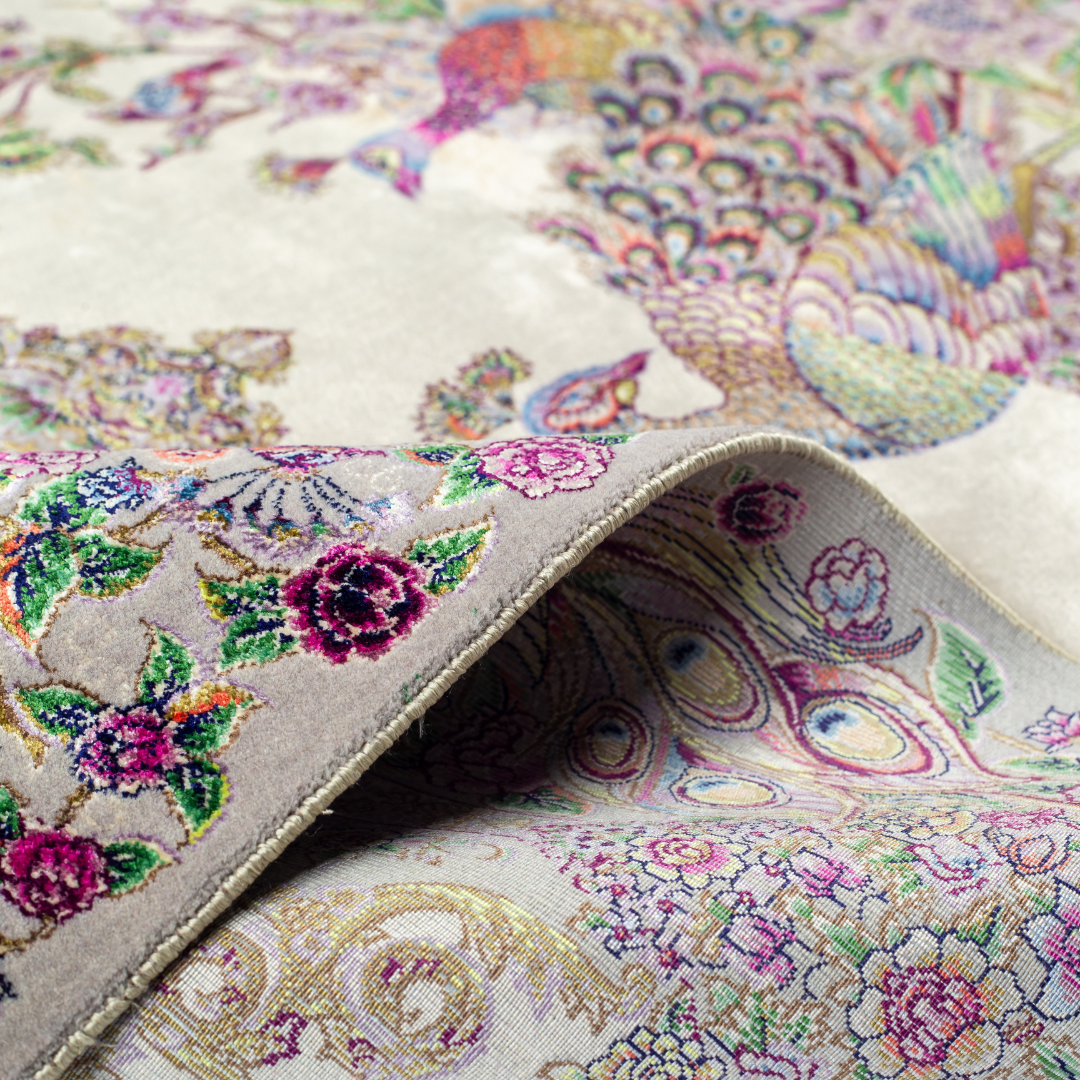 Luxurious ivory silk rug featuring peacocks, floral motifs, and intricate detailing, handcrafted with multicolored threads.