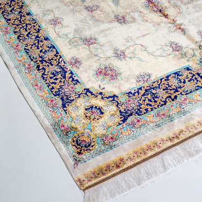 Close-up of the Drais silk rug showing intricate floral patterns, soft sheen and detailed design.