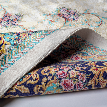 Close-up of the Drais silk rug showing intricate floral patterns, soft sheen and detailed design.