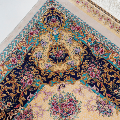 Close-up of the Drais silk rug showing intricate floral patterns, soft sheen and detailed design.