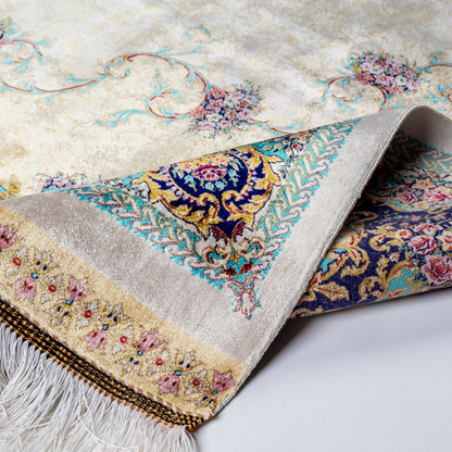 Close-up of the Drais silk rug showing intricate floral patterns, soft sheen and detailed design.