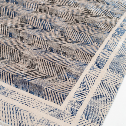 Eclipse cotton rug featuring a bold chevron pattern in grey, blue, and ivory with a distressed texture, perfect for contemporary interiors.