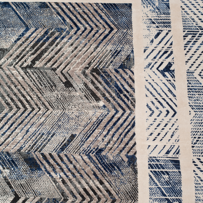 Eclipse cotton rug featuring a bold chevron pattern in grey, blue, and ivory with a distressed texture, perfect for contemporary interiors.