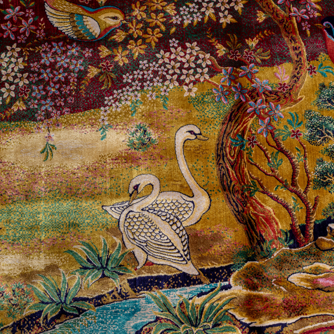 Silk rug with tree of life and bird motif, burgundy floral base, and ornate navy-gold borders. Handwoven with artistic precision.


