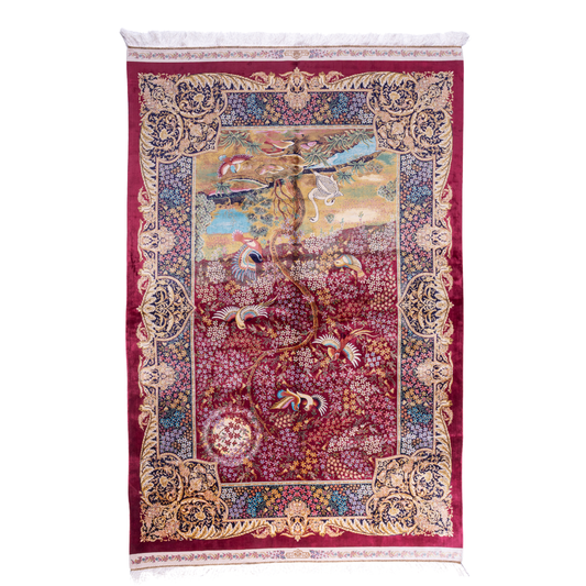 Silk rug with tree of life and bird motif, burgundy floral base, and ornate navy-gold borders. Handwoven with artistic precision.


