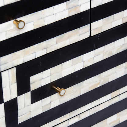 Black bone inlay chest of drawers with curved corners, brass knobs, and maze-inspired geometric design, handcrafted for modern interiors.