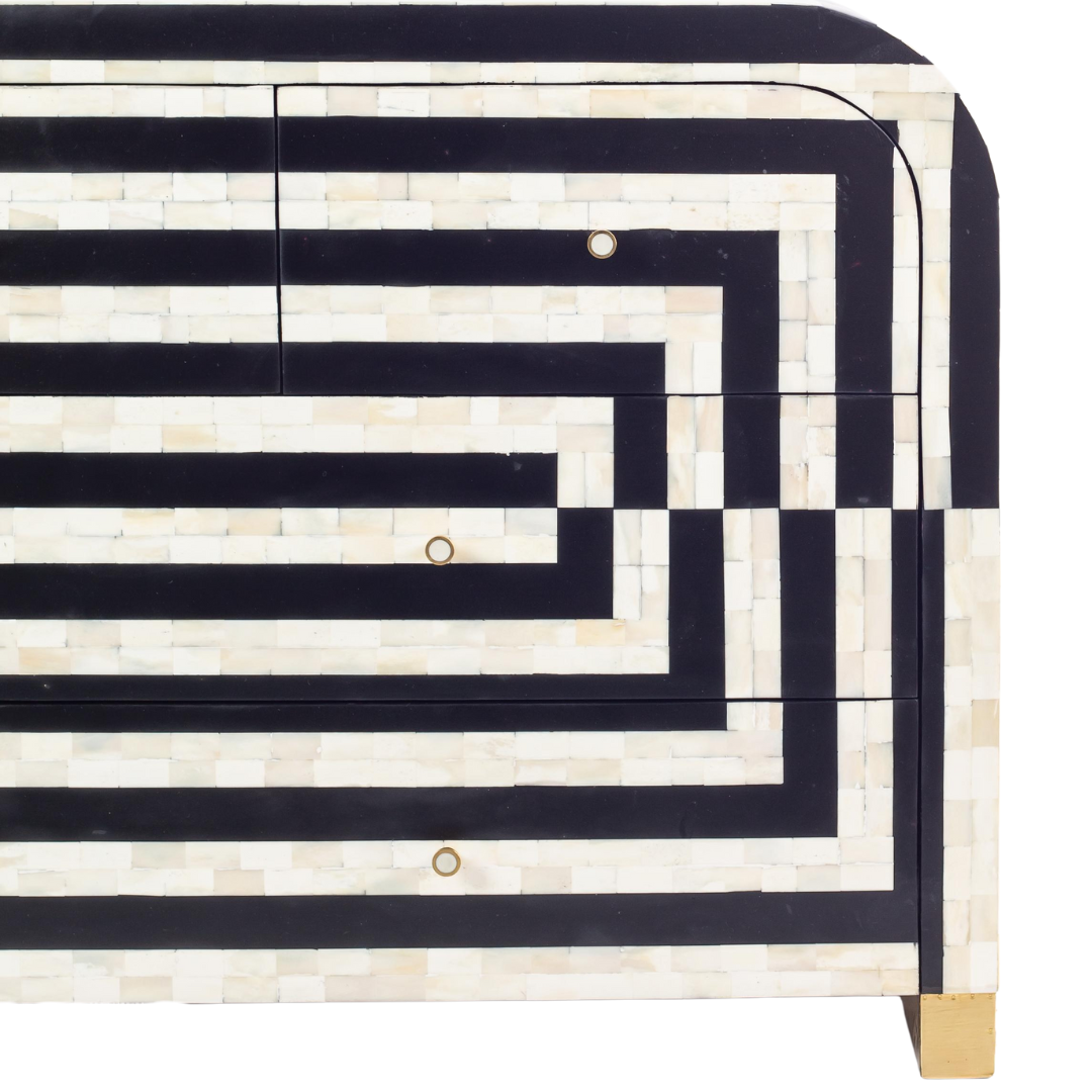 Black bone inlay chest of drawers with curved corners, brass knobs, and maze-inspired geometric design, handcrafted for modern interiors.