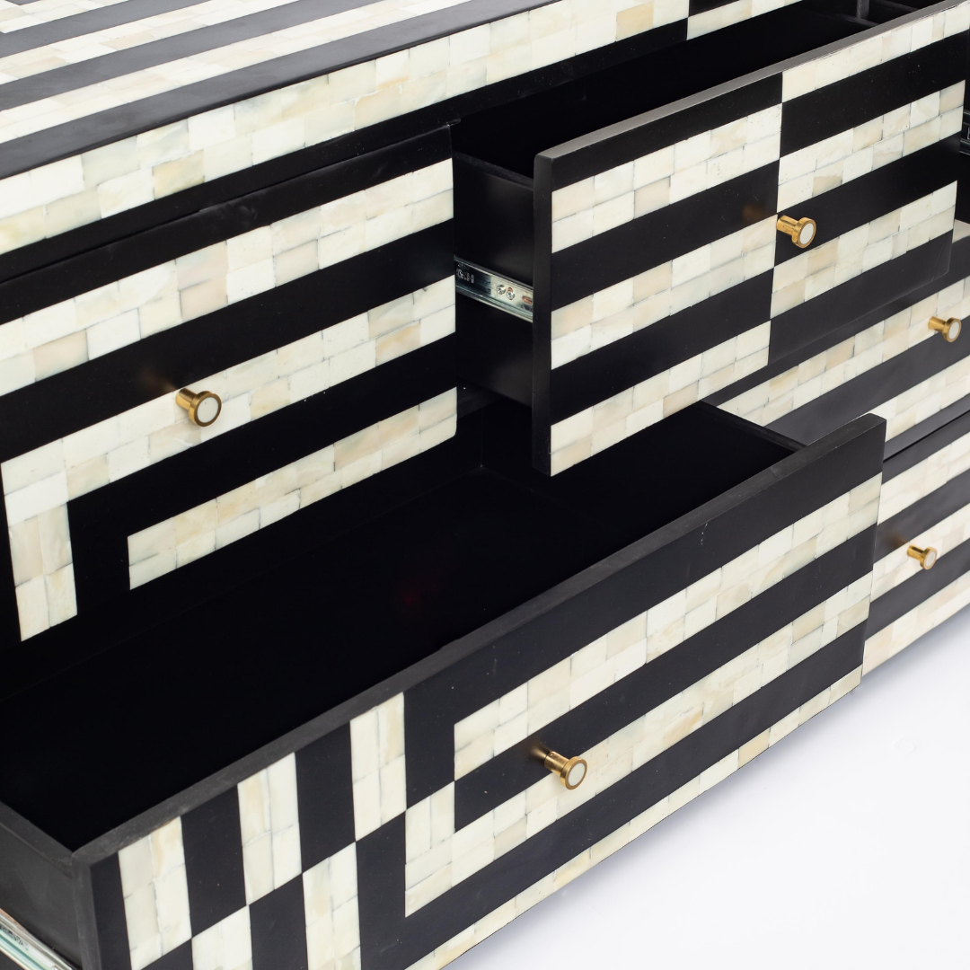 Black bone inlay chest of drawers with curved corners, brass knobs, and maze-inspired geometric design, handcrafted for modern interiors.