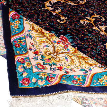 Elegant navy silk rug with detailed floral medallion, ornate cream border, and rich design in gold, coral, and turquoise tones.