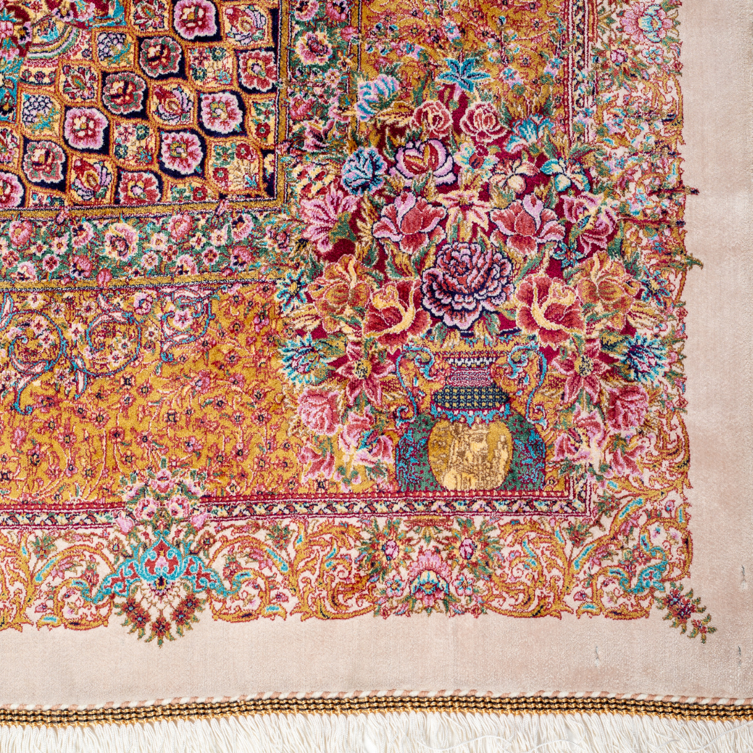 Silk Flow rug with a floral rosette medallion, ivory base, and ornate border in saffron, turquoise, plum, and blush tones.